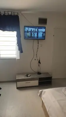 a living room with a tv on the wall at Apartman Sava in Niš