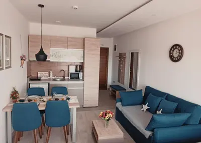 a living room with a blue couch and a table at Milmari S30 in Kopaonik