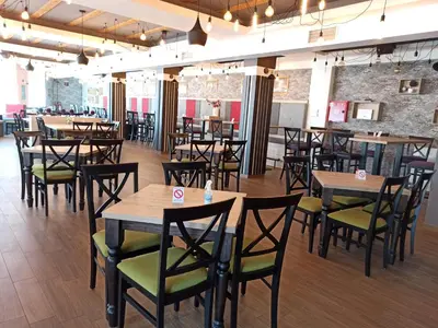 a restaurant with tables and chairs in a room at Milmari S30 in Kopaonik
