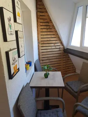 a table and chairs in a room with a staircase at Košuta 21 Center Duplex Apartment, Brzeće in Brzeće