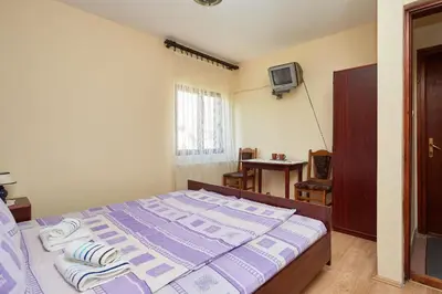 a bedroom with a bed with towels on it at Apartmani Stojadinović in Soko Banja