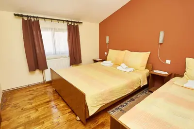 a hotel room with two beds and a window at Apartmani Stojadinović in Soko Banja