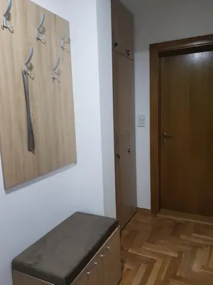 a room with a door and a bench in a room at Apartman Kala in Vrnjačka Banja