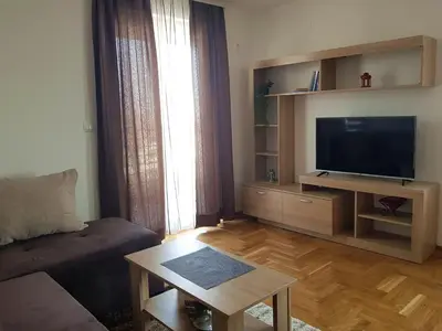a living room with a couch and a flat screen tv at Apartman Kala in Vrnjačka Banja