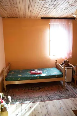 a bed in a room with a window at Apartment Luka-Lena in Kopaonik