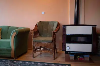 a living room with a chair and a tv at Apartment Luka-Lena in Kopaonik