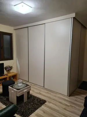 a living room with a large white closet at Apartment Luka-Lena in Kopaonik