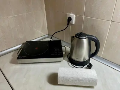 a coffee maker and a tea kettle on a counter at Lili apartman u parku in Vrnjačka Banja