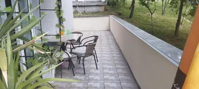 a balcony with a table and chairs on it at PremiumPlus Apartman in Vrnjačka Banja