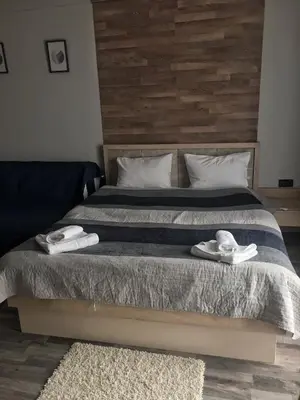 a bedroom with a bed with two towels on it at Studio Milmari ,Premier 18 in Kopaonik