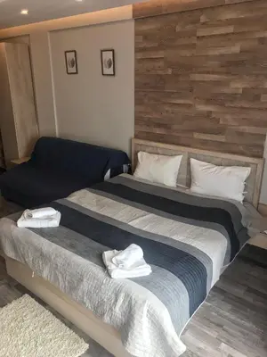 two beds in a hotel room with white towels on them at Studio Milmari ,Premier 18 in Kopaonik