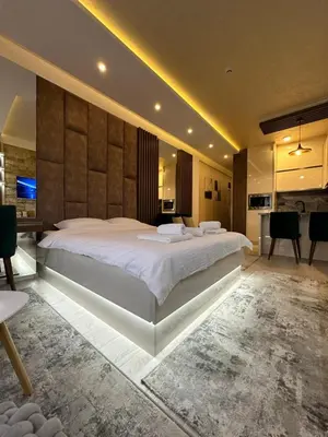a bedroom with a large white bed in a room at Apartmani Fashion -Milmari Resort in Kopaonik