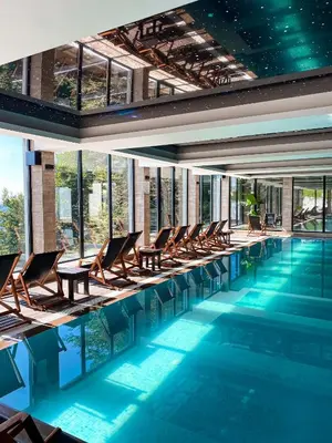 a swimming pool with lounge chairs and a swimming pool at Apartmani Fashion -Milmari Resort in Kopaonik