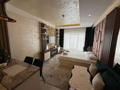 a hotel room with a bed and a table at Apartmani Fashion -Milmari Resort in Kopaonik
