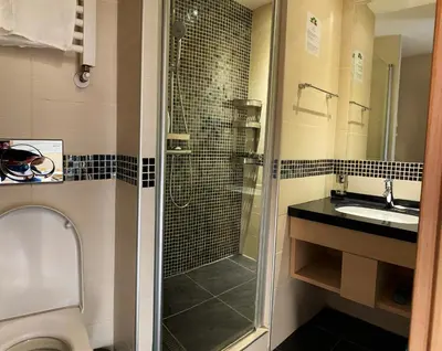 a bathroom with a shower and a toilet and a sink at Family Lux Apartmani Angella Konaci in Kopaonik