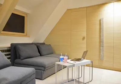 a living room with a couch and a laptop on a table at Family Lux Apartmani Angella Konaci in Kopaonik