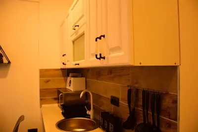 a kitchen with a sink and white cabinets at Apartman Suny N58 in Kopaonik