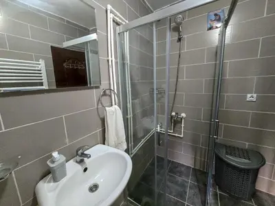 a bathroom with a sink and a glass shower at Seosko domaćinstvo „GABAR” in Ćuštica