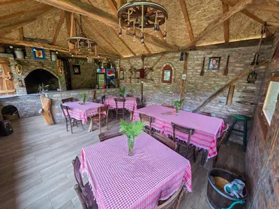 a dining room with pink tables and chairs at Seosko domaćinstvo „GABAR” in Ćuštica