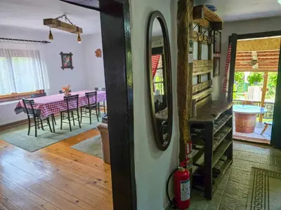 a dining room with a table and a mirror at Seosko domaćinstvo „GABAR” in Ćuštica