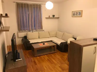 a living room with a couch and a table at Kopaonik Foka Spa Brzeće in Brzeće
