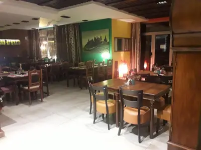 a dining room with tables and chairs in a restaurant at Kopaonik Foka Spa Brzeće in Brzeće