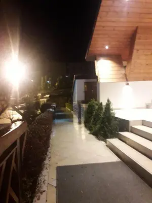 a street light next to a house at night at Kopaonik Foka Spa Brzeće in Brzeće