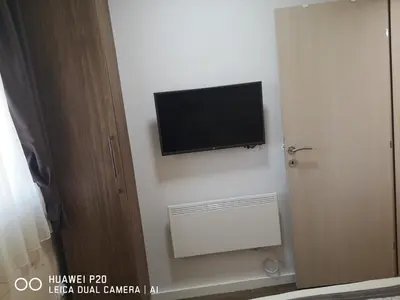 a flat screen tv on the wall of a room at KOPAONIK HOUSE in Kopaonik