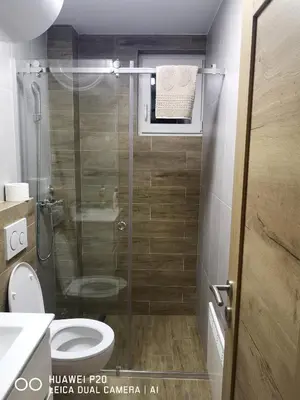 a bathroom with a shower with a toilet and a sink at KOPAONIK HOUSE in Kopaonik