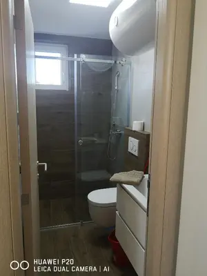 a bathroom with a toilet and a glass shower at KOPAONIK HOUSE in Kopaonik