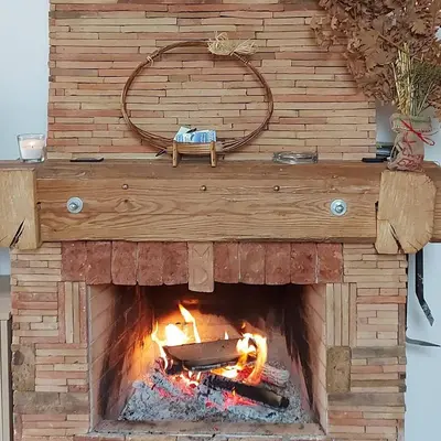 a brick oven with a fire in it at KOPAONIK HOUSE in Kopaonik