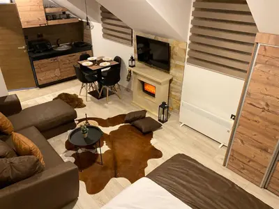a living room with a couch and a table at Studio Apartment Station Kopaonik,Milmari Resort in Kopaonik
