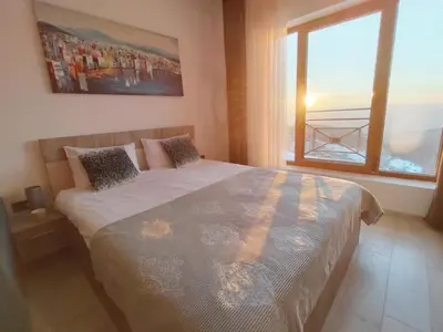 a bedroom with a large bed and a window at APARTMAN BIKI in Kopaonik
