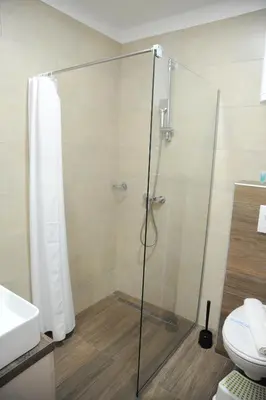 a shower with a glass door in a bathroom at APARTMAN BIKI in Kopaonik