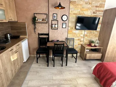 a kitchen and dining room with a table and chairs at Nana S44 Milmari Spa&Wellness in Kopaonik