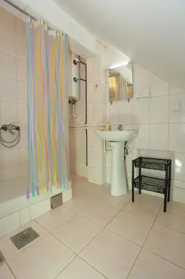a bathroom with a sink and a shower curtain at Apartman Carpe Diem 2 in Zaječar