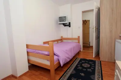 a bedroom with a bed with a purple blanket at Apartman Carpe Diem 2 in Zaječar