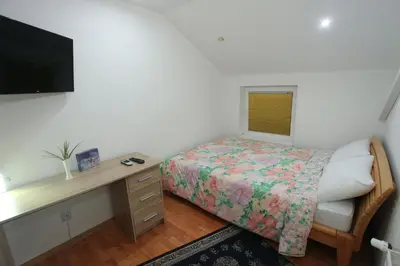a small bedroom with a bed and a desk at Apartman Carpe Diem 2 in Zaječar