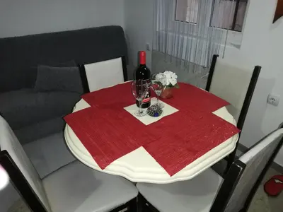 a table with a wine bottle and two glasses on it at Andrina Sweet Home in Niš