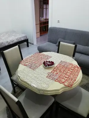 a table with a bowl of fruit on top of it at Andrina Sweet Home in Niš