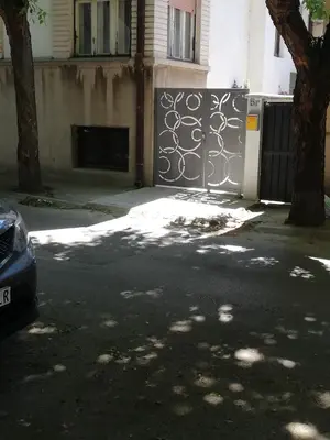 a gate in front of a building with a tree at Andrina Sweet Home in Niš