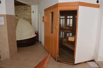 a wooden cabinet in a room with a tub at Apartman “EMI” in Kopaonik