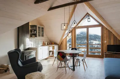 a kitchen and living room with a table and chairs at Kostovac Boutique Homes - Loft in Kopaonik