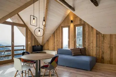 a living room with a blue couch and a table at Kostovac Boutique Homes - Loft in Kopaonik