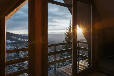 a window with a view of the snow covered mountains at Kostovac Boutique Homes - Loft in Kopaonik