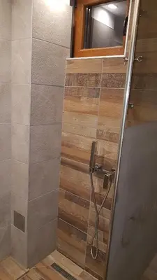 a shower with a glass door in a bathroom at Milmari Premijer 30 Kopaonik in Kopaonik