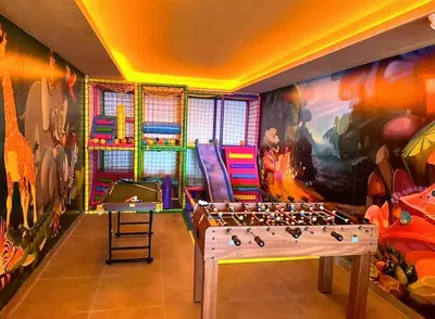 a room with a chess board in front of a mural at Kopaonik Milmari Spa and Wellness Wooden Horn S21 in Kopaonik