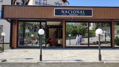 a store front with a sign for a national restaurant at Kopaonik Milmari Spa and Wellness Wooden Horn S21 in Kopaonik