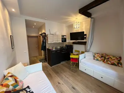 a living room with a couch and a kitchen at Apartman Brvenik 103, Konaci, Kopaonik in Kopaonik