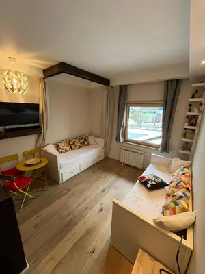 a small room with a bed and a window at Apartman Brvenik 103, Konaci, Kopaonik in Kopaonik